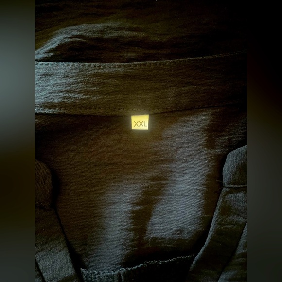 This blouse is a black patchwork short sleeve V neck blouse. - Picture 5 of 5